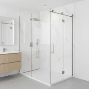 A bright, modern walk-in shower with smooth, solid-surface white marble-patterned acrylic walls. The shower features a low-profile entry base, a clear glass sliding door, and sleek brushed nickel fixtures. No tile grout lines, no free-standing bathtubs, no text, clean and contemporary bathroom interior.